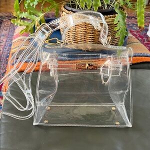 Fashionable Clear Bag with handle and cross body strap.